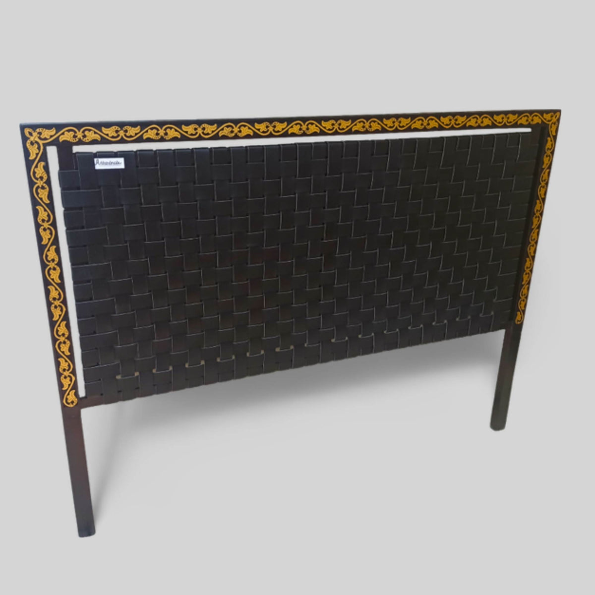 Side angle showing leather strap detail and carved wood frame
