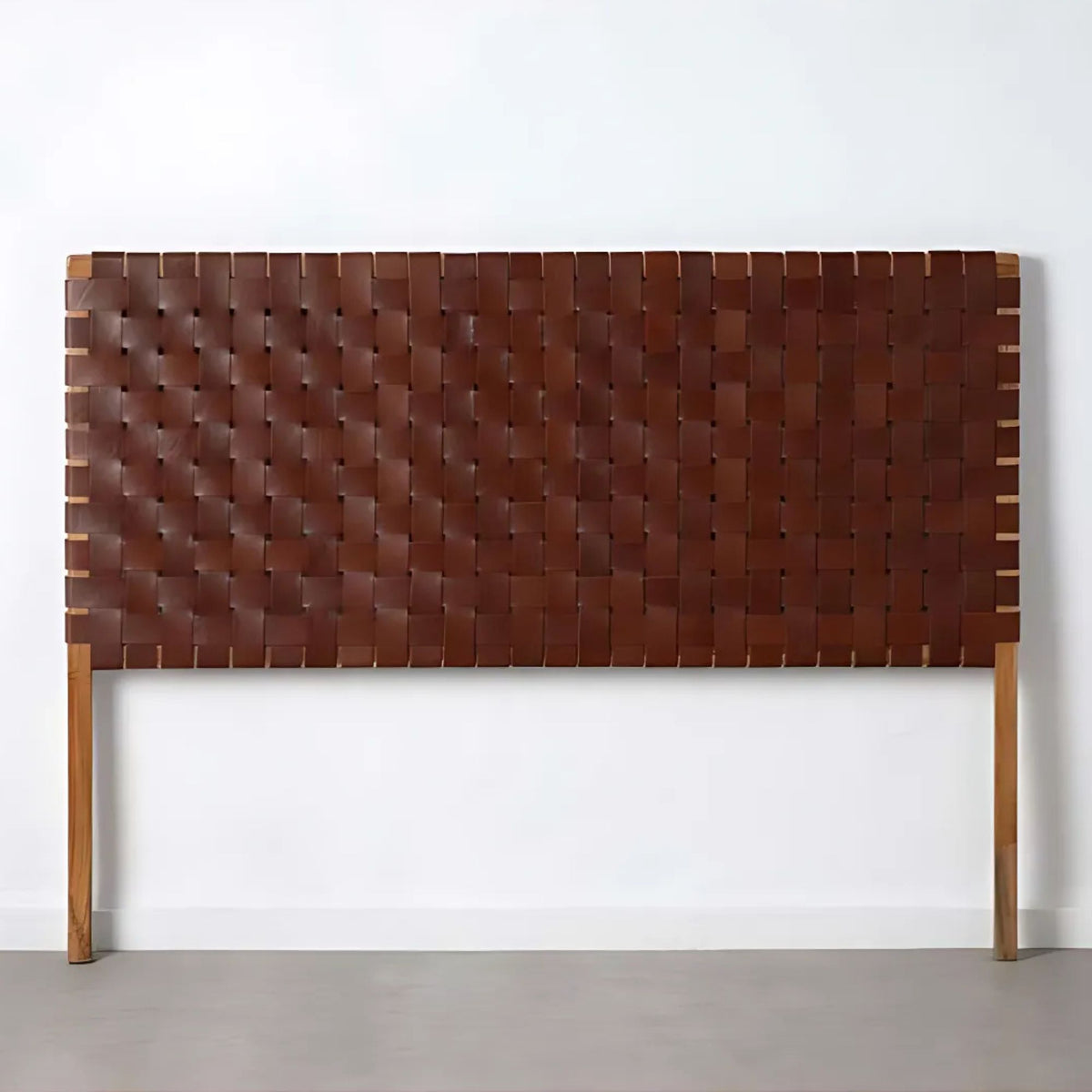 Detail of Artihandmade® full grain leather headboard, showcasing hand-tooled strap texture.