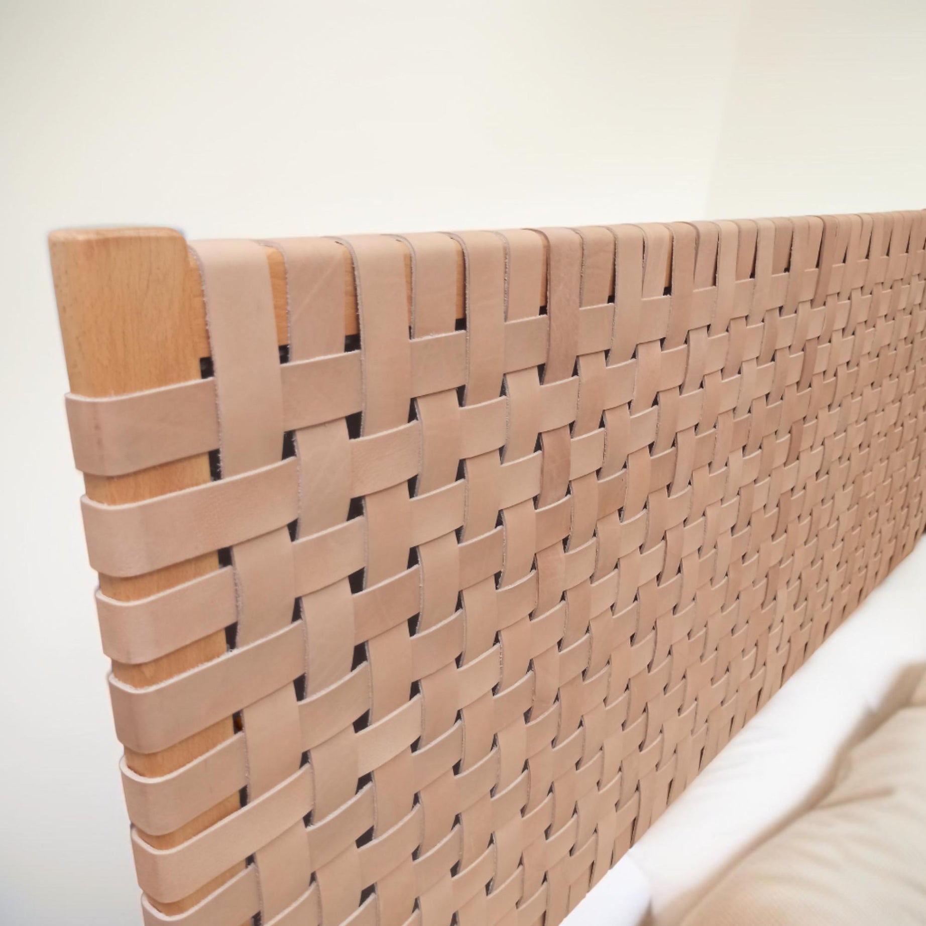 Side profile of a contemporary strap woven leather headboard highlighting its dynamic structure queen size headboard.