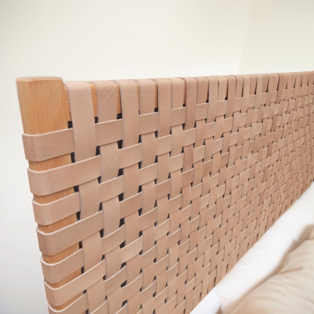 Side profile of a contemporary strap woven leather headboard highlighting its dynamic structure queen size headboard.