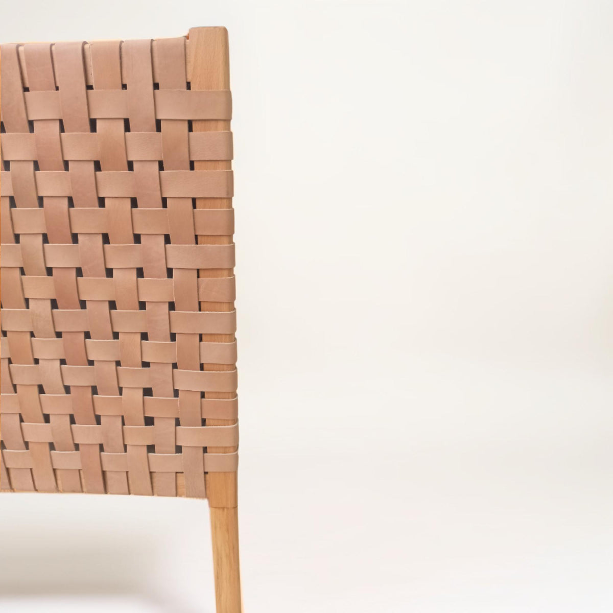 Close-up shot of the leather straps on a king headboard detailing the intricate weaving.