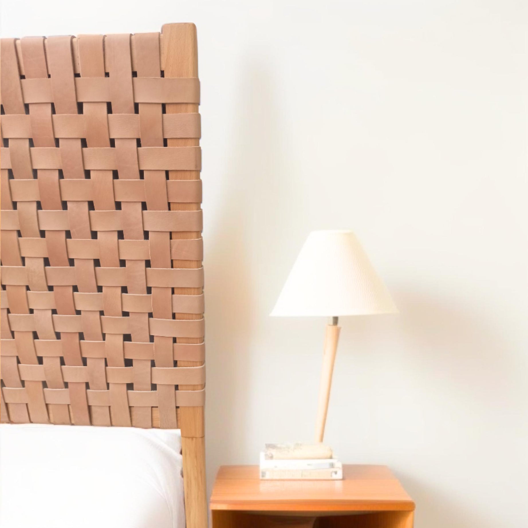 Close-up shot of the leather straps king headboard detailing the intricate weaving.